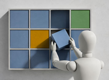 Manichino che inserisce un cubo in una griglia di competenze, metafora delle soft skills nelle PMI e della selezione del personale.